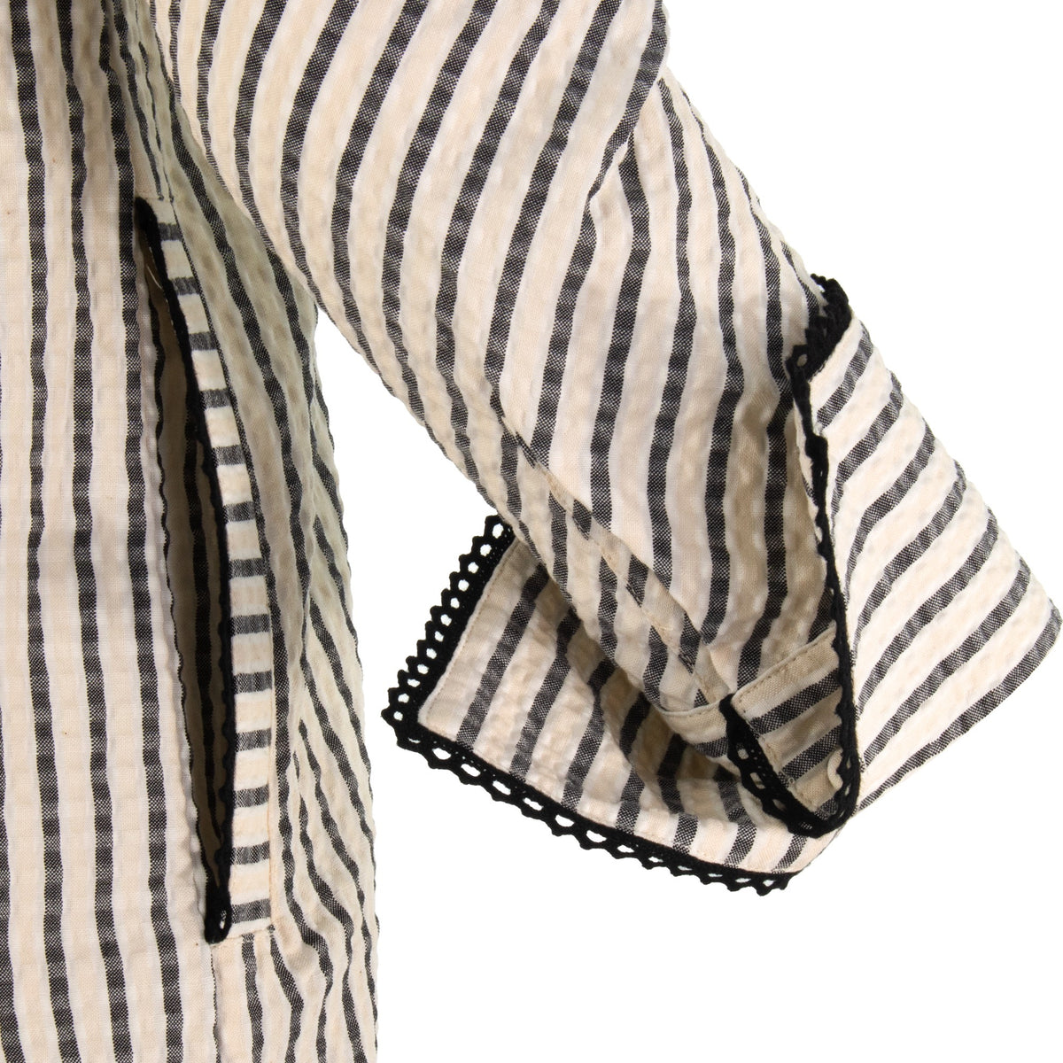 The Urbino striped long sleeve collared pop-over shirt dress with vertical stripes, relaxed lapel neckline, contrast black trim detail, and lightweight breathable fabric