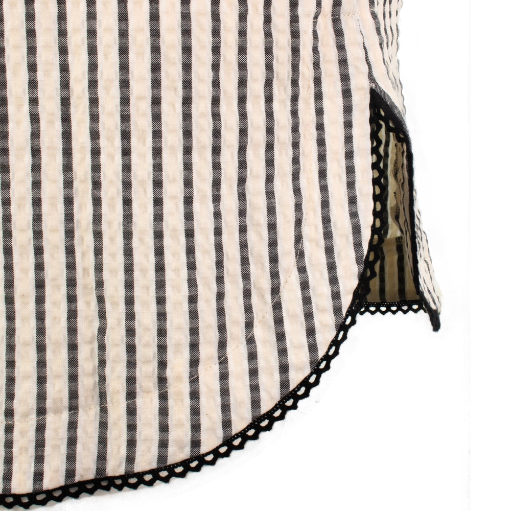 The Urbino striped long sleeve collared pop-over shirt dress with vertical stripes, relaxed lapel neckline, contrast black trim detail, and lightweight breathable fabric