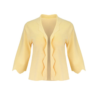 The Thalassa Stolen Softness bolero cardigan jacket with 3/4 sleeves, scalloped edge trim along center front and cuffs, fluid draped silhouette, and softly sculpted knit shape
