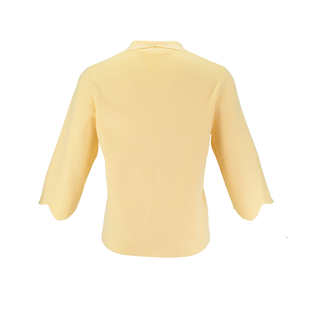 The Thalassa Stolen Softness bolero cardigan jacket with 3/4 sleeves, scalloped edge trim along center front and cuffs, fluid draped silhouette, and softly sculpted knit shape