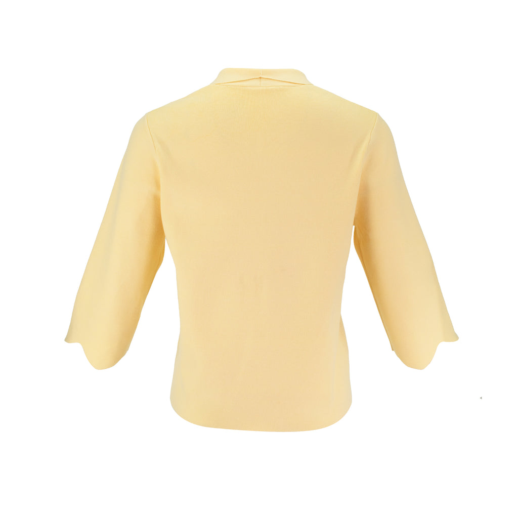 The Thalassa Stolen Softness bolero cardigan jacket with 3/4 sleeves, scalloped edge trim along center front and cuffs, fluid draped silhouette, and softly sculpted knit shape