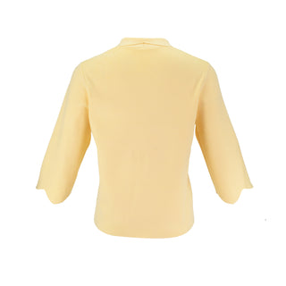 The Thalassa Stolen Softness bolero cardigan jacket with 3/4 sleeves, scalloped edge trim along center front and cuffs, fluid draped silhouette, and softly sculpted knit shape