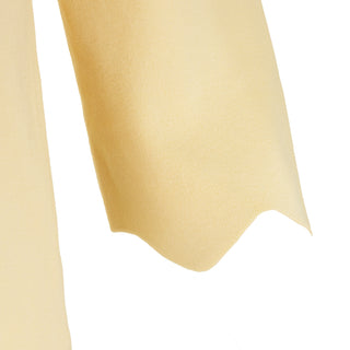 The Thalassa Stolen Softness bolero cardigan jacket with 3/4 sleeves, scalloped edge trim along center front and cuffs, fluid draped silhouette, and softly sculpted knit shape