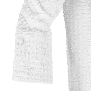 The Gabby Odyssey Check stretch pop-over tunic blouse with textured bubble fabric, collared neckline, long sleeves, front placket, and black Akoya cuff buttons