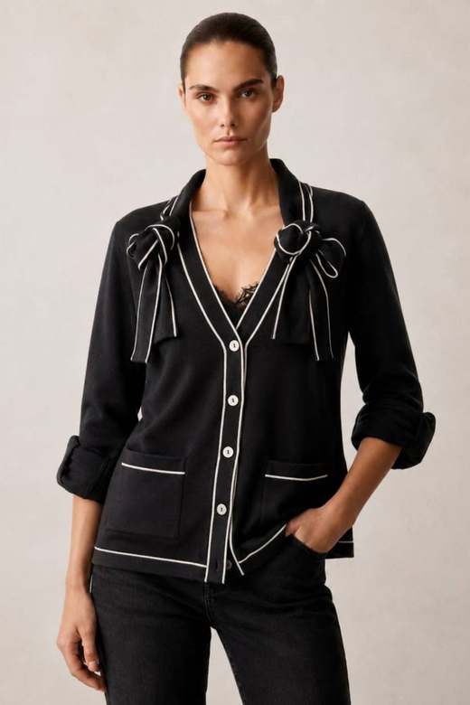 A Stolen Softness cardigan with ivory tipping and a bow tie