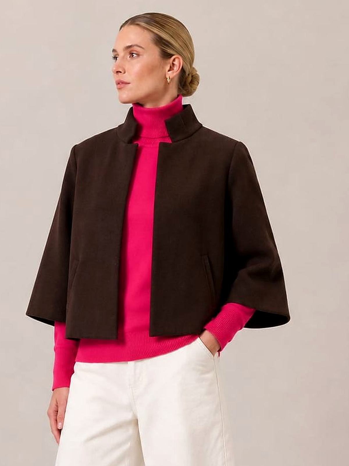A woman in the Bristol Jacket in French Toast over a hot pink turtleneck