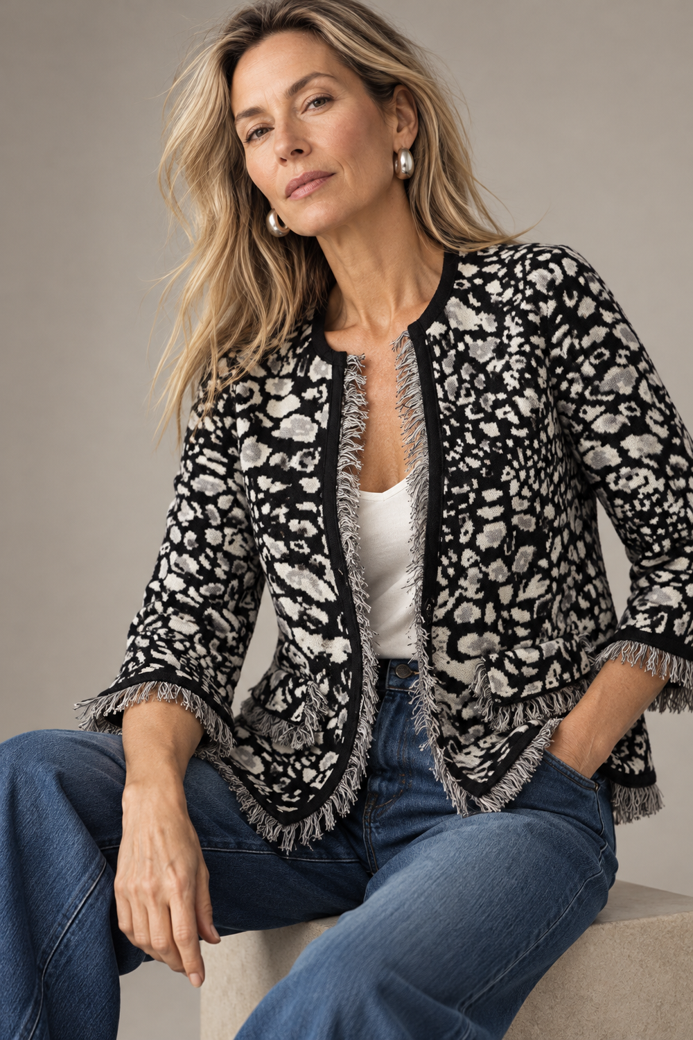 The Cervia Jacket in black and ivory animal print with fringe trim, over the Tammy tank, with jeans