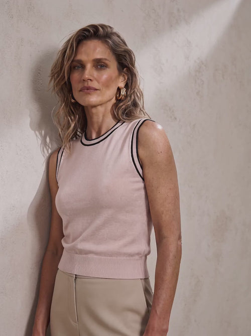 The Roanne sleeveless cotton crew-neck knit top featuring contrast varsity-inspired tipping along the neckline and armholes.